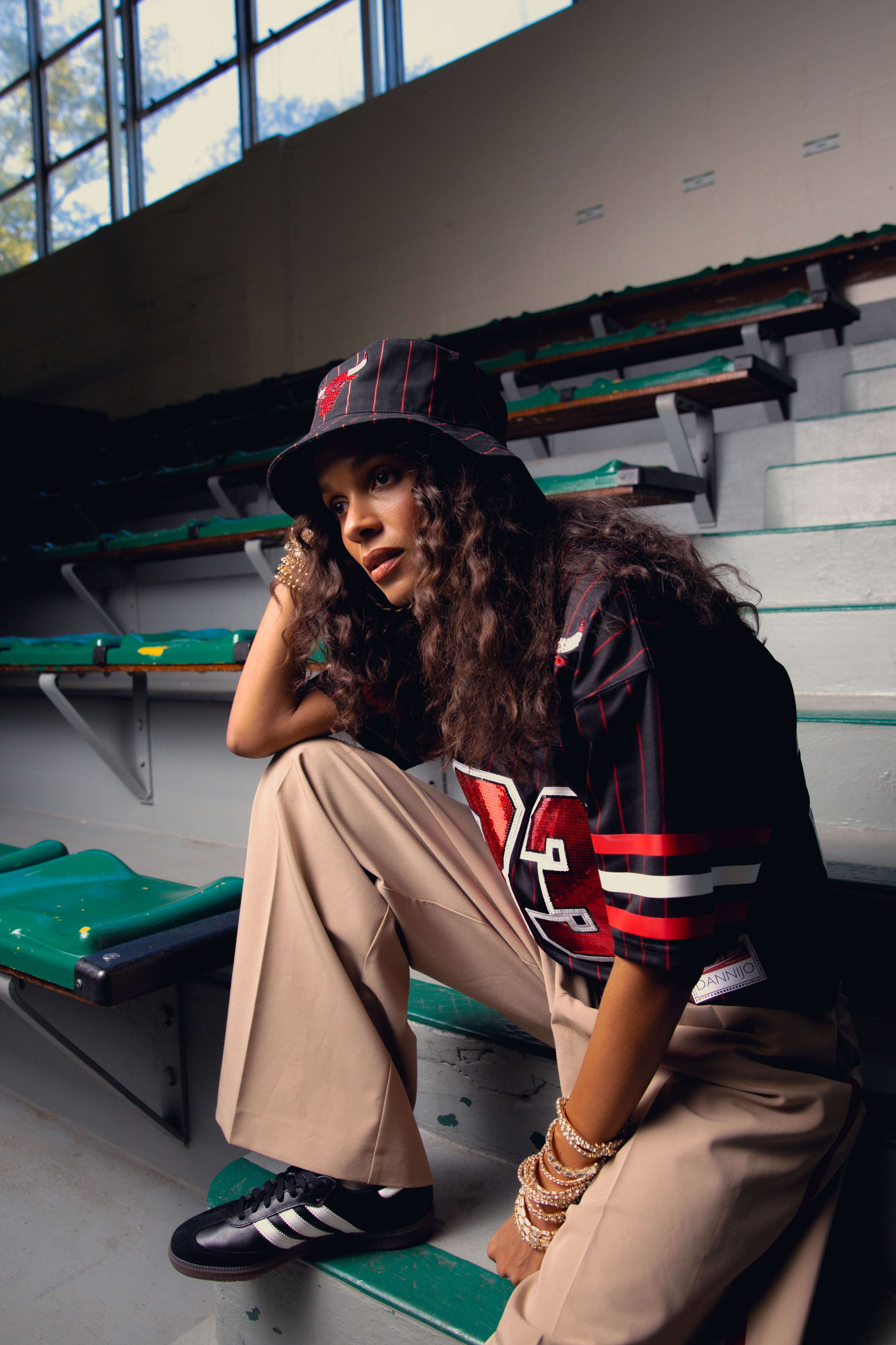 Woman wearing Scottie Pippen Chicago Bulls rhinestone crop football jersey sitting in stadium bleachers