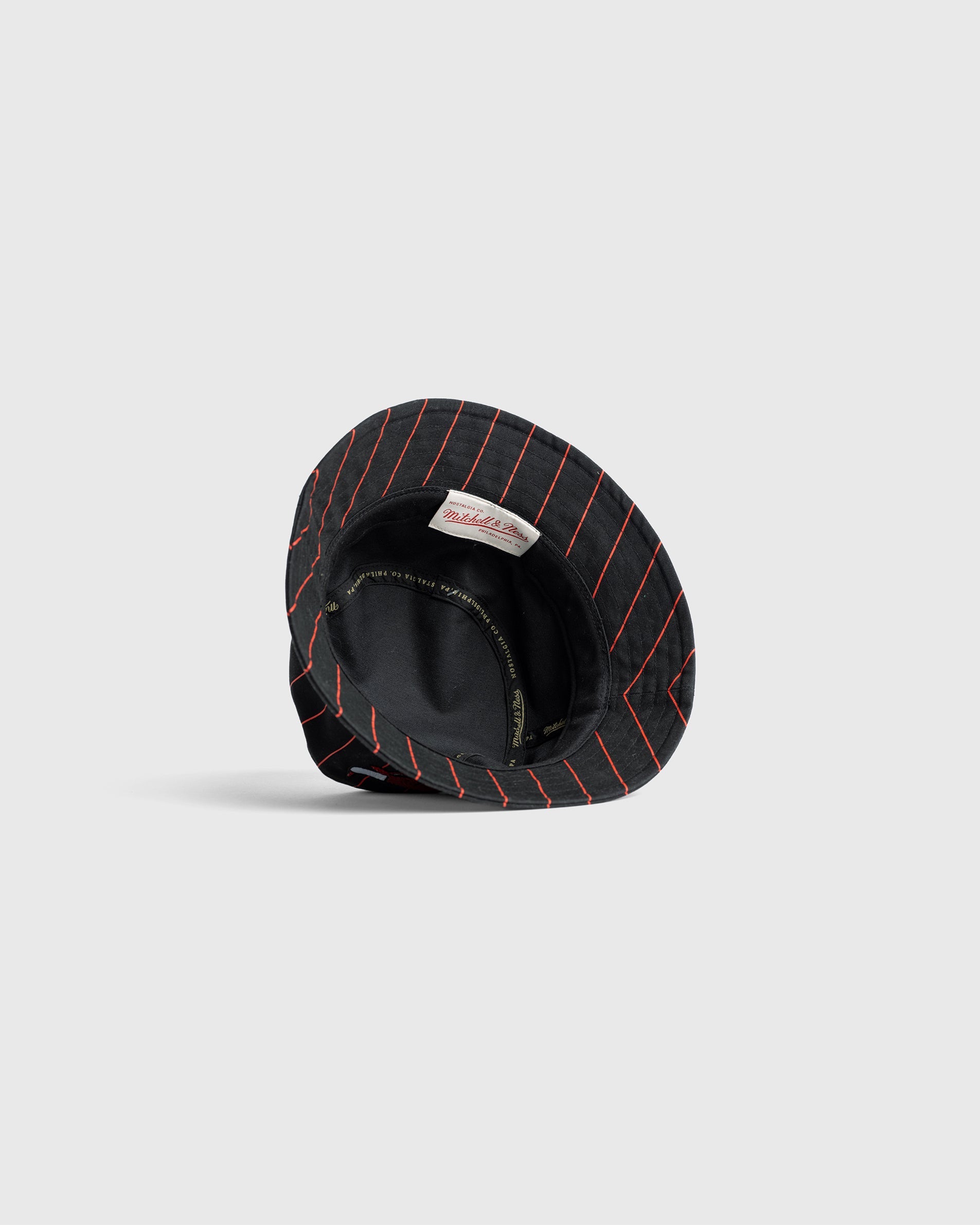 Chicago Bulls Bucket Hat with black fabric and red pinstripes, showing inner lining and embroidered logo design