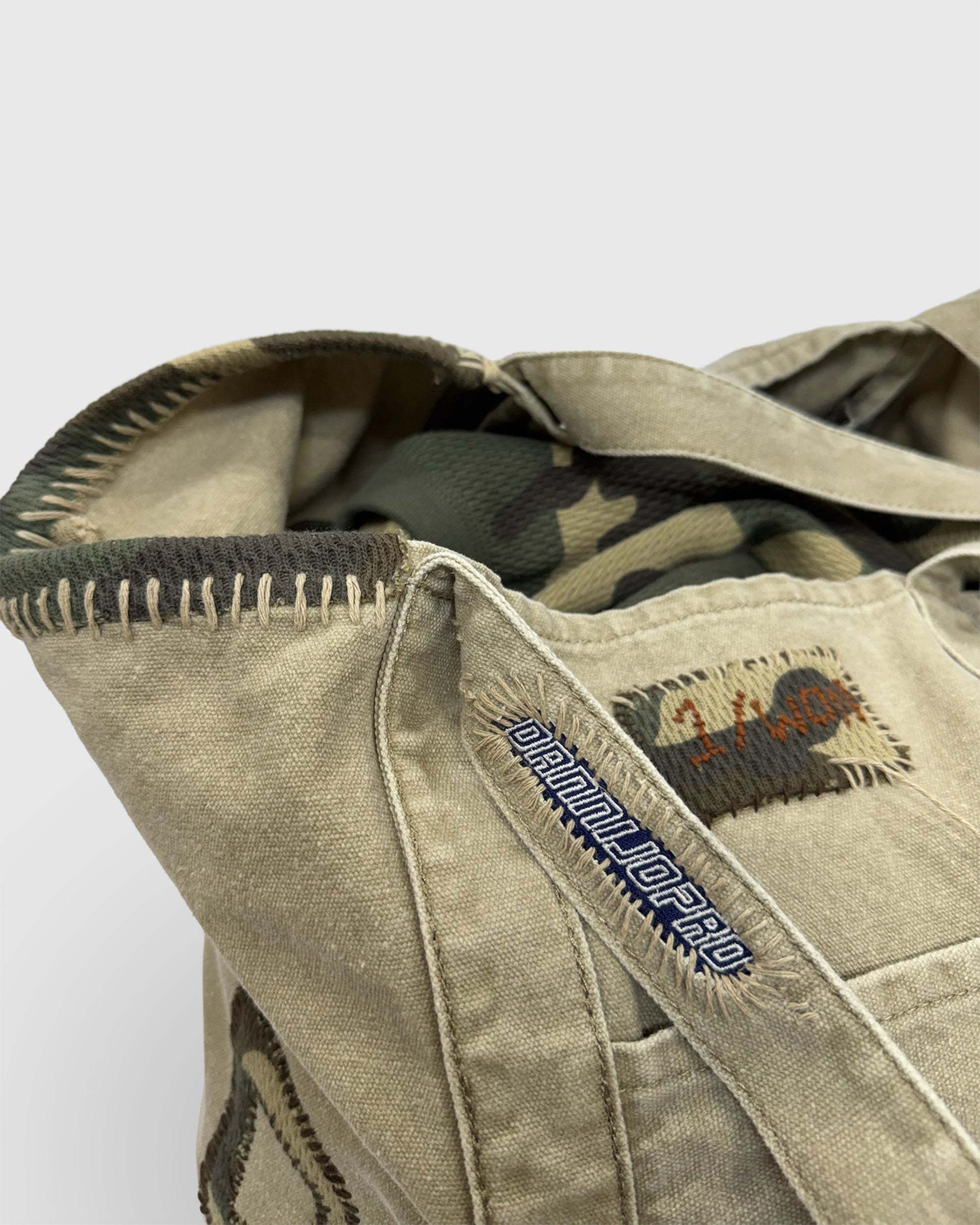 Hand stitched camo initial bag with distressed finish, ideal for market, beach, or gym use