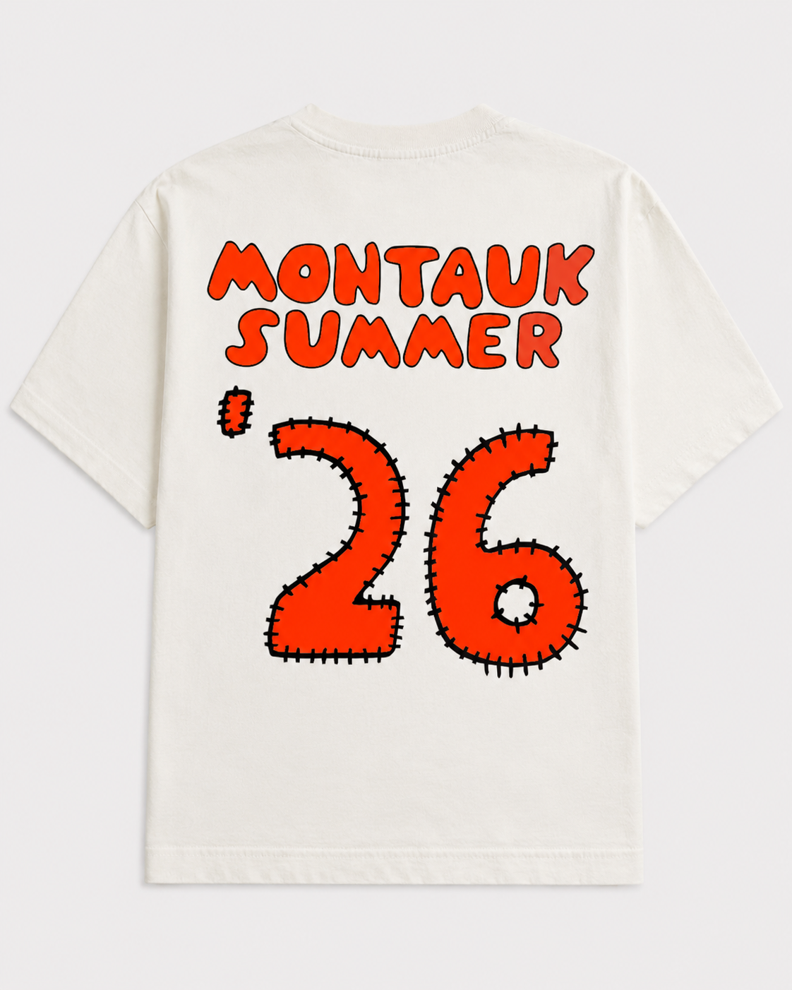 An off-white short-sleeve t-shirt with a graphic print on the back featuring the text 'MONTAUK SUMMER' in orange-red letters and a large '26' in a cactus-like stitched font, also in orange-red with black outlines.