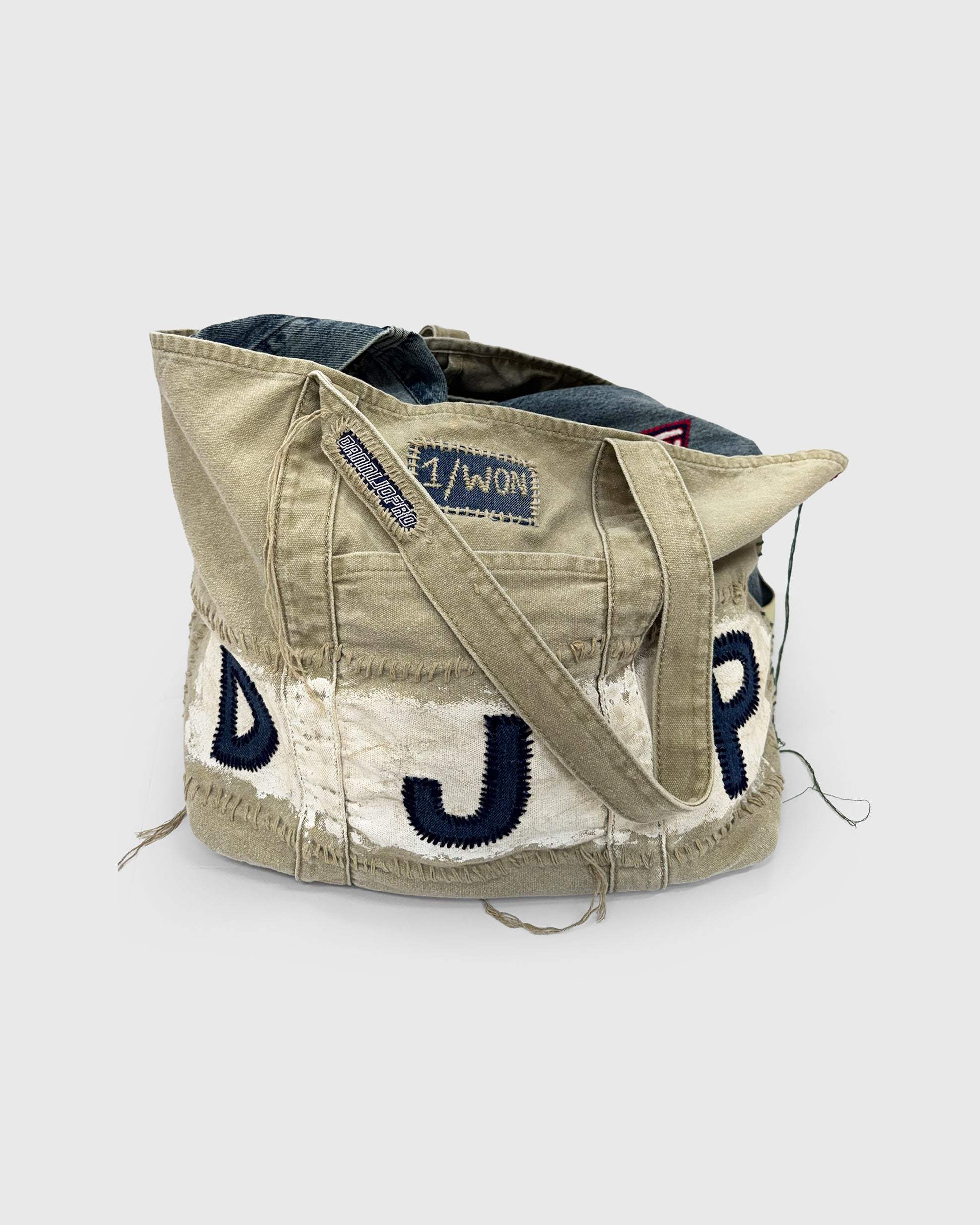 Hand-stitched Denim Initial Bag with distressed design and custom initials, perfect for everyday use.