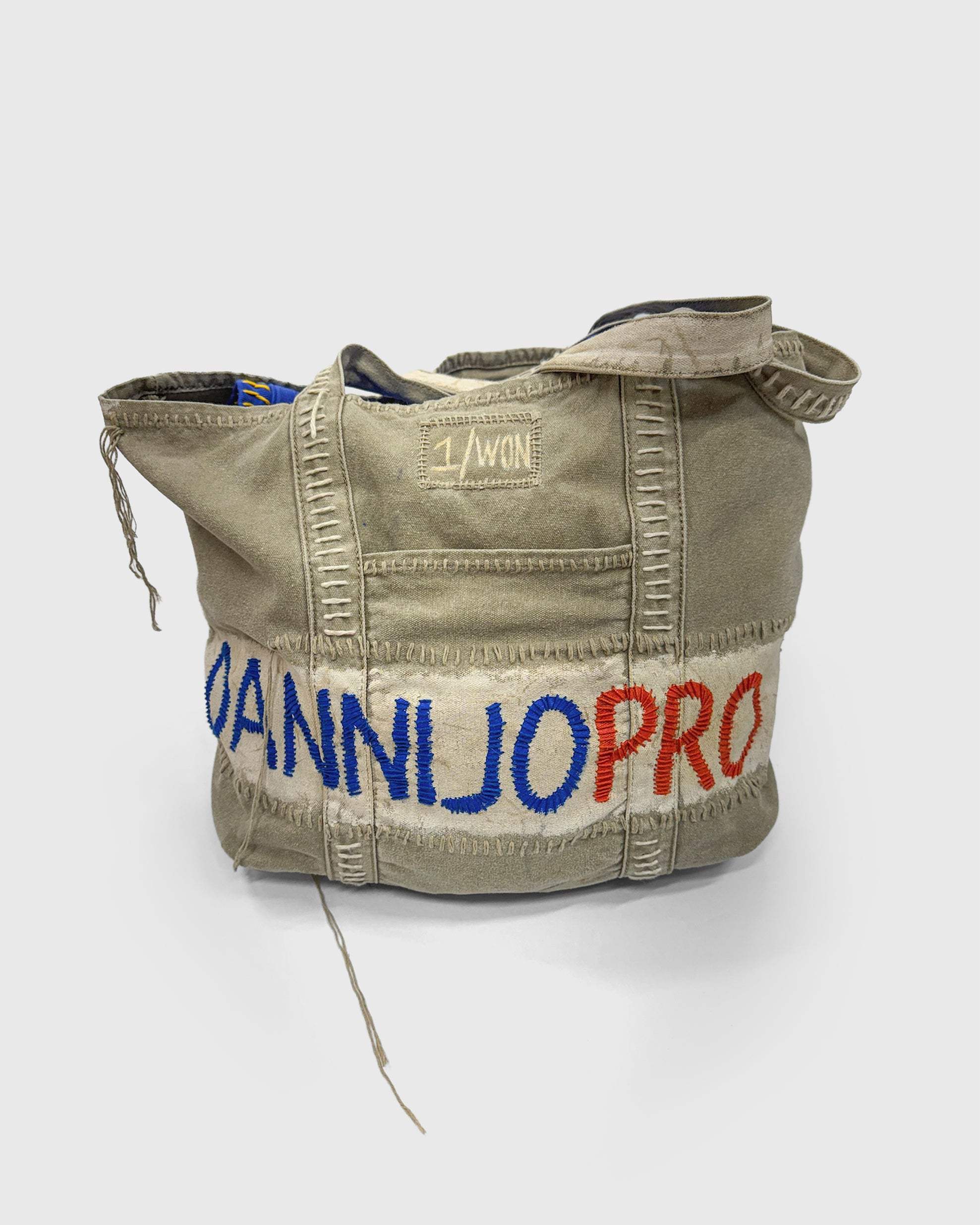 WON DANNIJOPRO Bag in orange and blue with hand-stitched, distressed canvas design