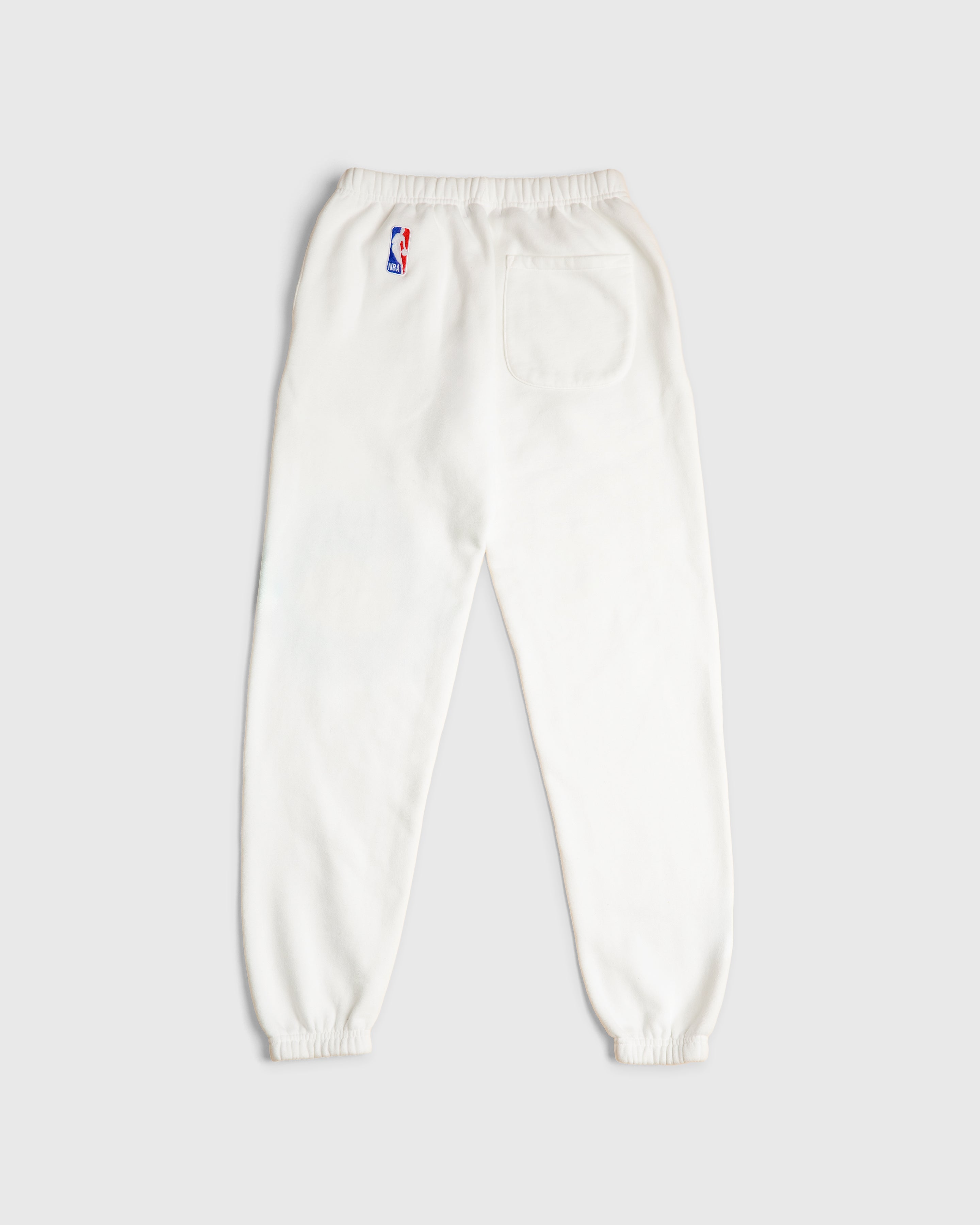 white sweat pants with the NBA logo on it
