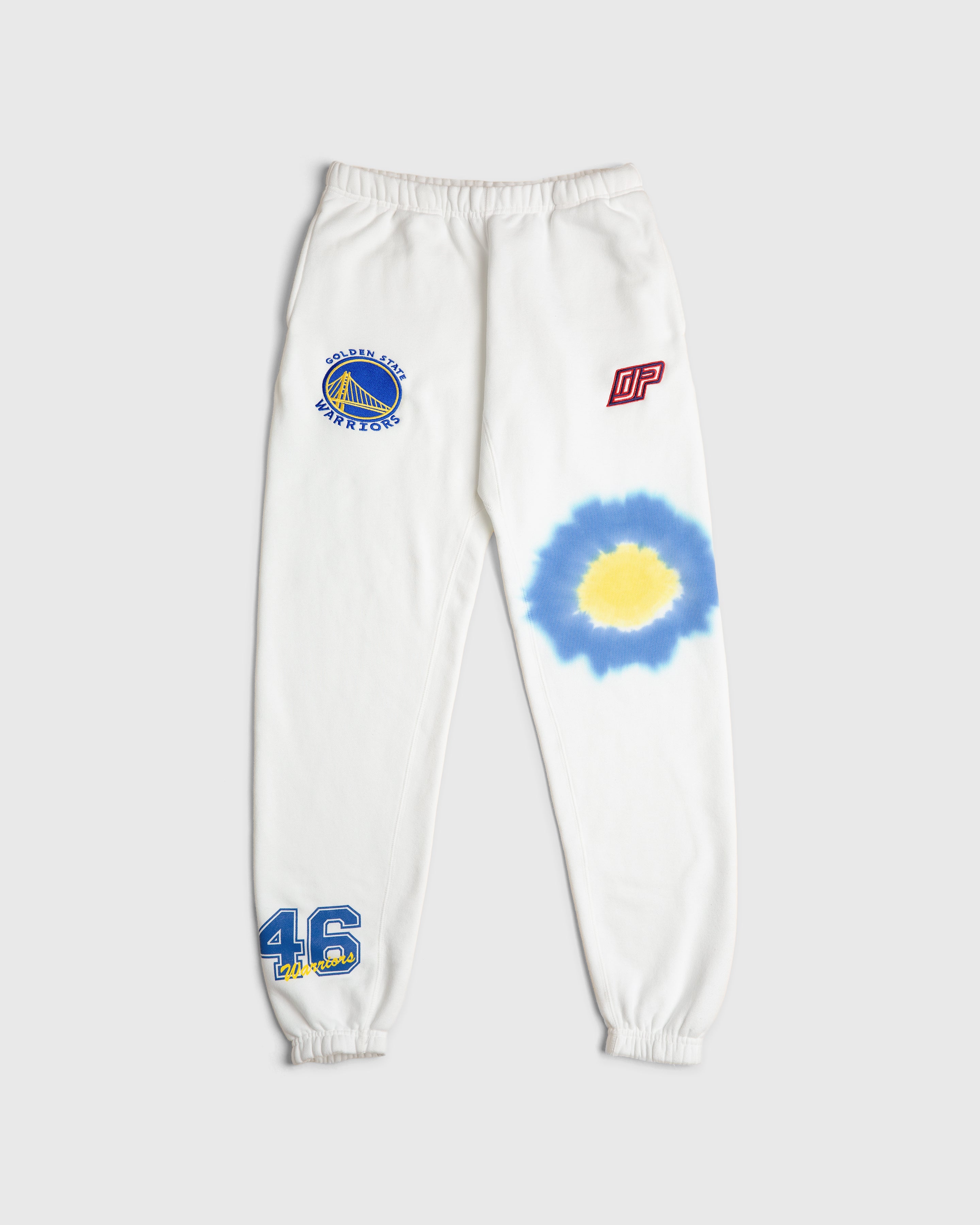 White sweatpants with Golden State Warriors team emblem and a tie-dye design on the leg, featuring the number 46.