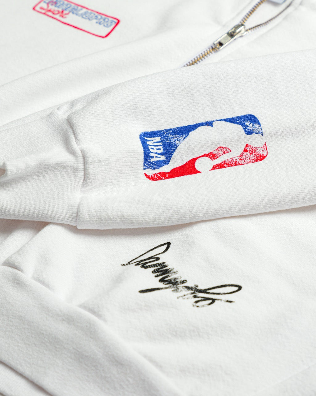 white jacket with NBA logo and signature on a white background