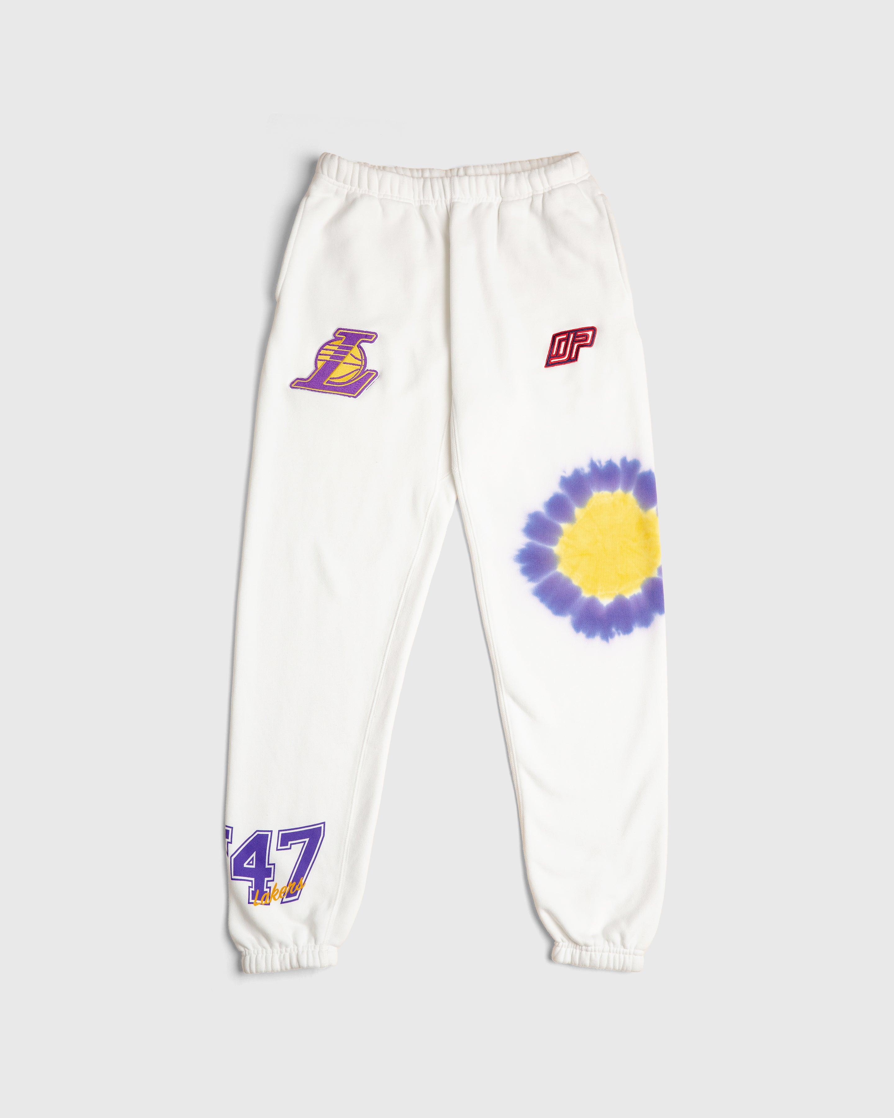 white sweatpants with Los Angeles Lakers team emblem and tie-dye details on the legs, featuring purple and yellow text and graphics