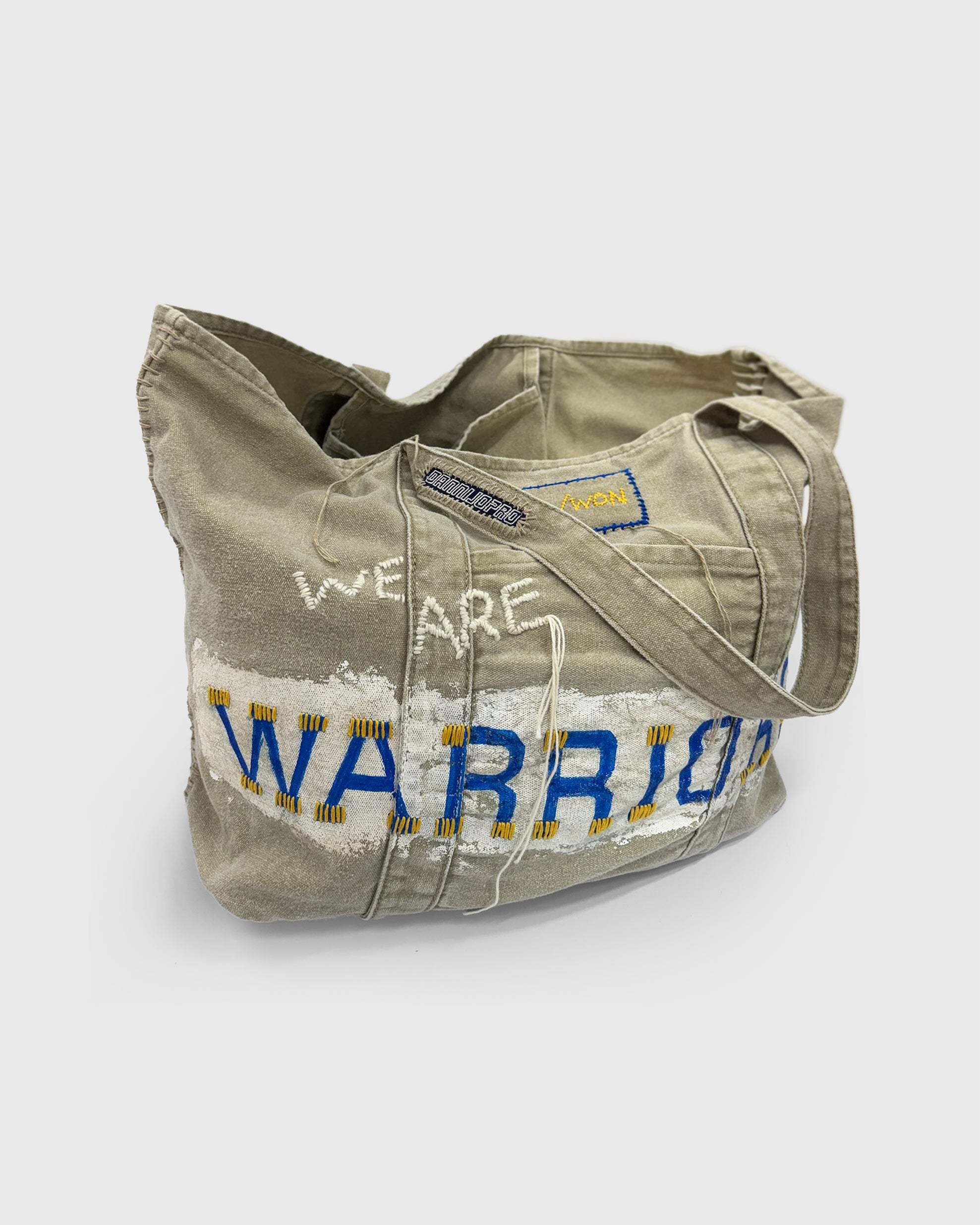 WON Warriors Bag hand stitched distressed NBA tote bag in beige with blue and yellow text